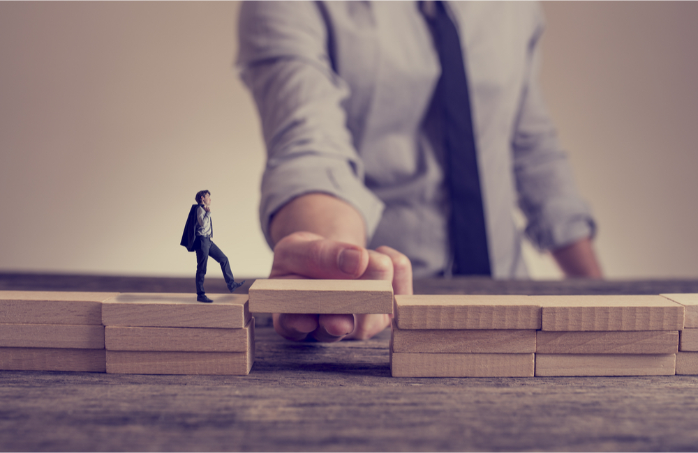 Trusted Gatekeepers: Conceptual image of hand holding up bridge