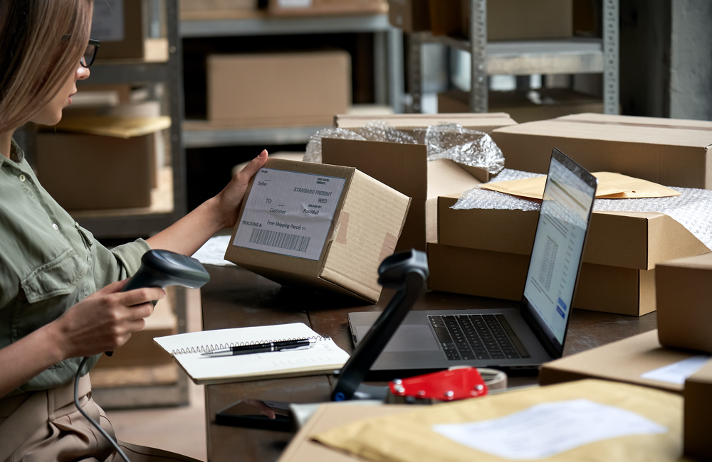 Shopify earnings and the state of digital: Woman preparing boxes for shipment