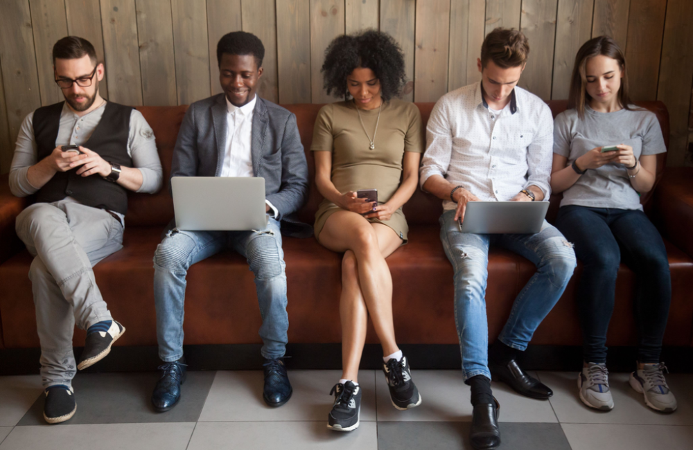 Photo of young people using mobile phones, tablets, and laptops to illustrate the current state of digital