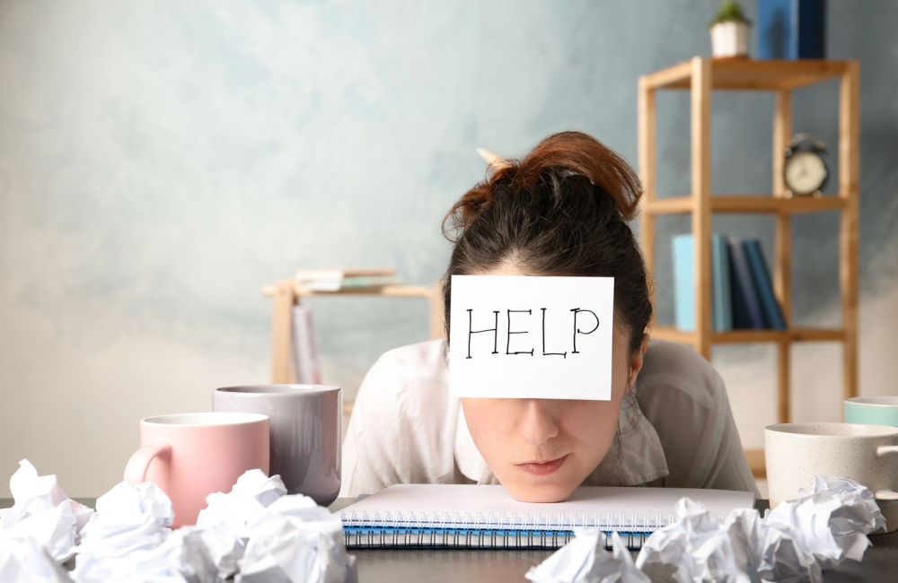 Woman with postcard that says "help" to illustrate the need to think about who speaks for your business