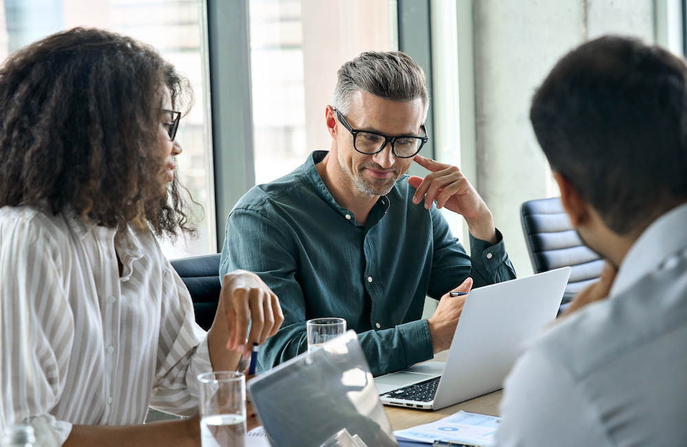 Team of executives reviewing how to add AI to their team