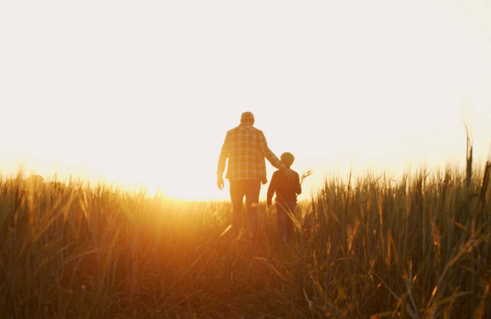 Photo of farmer and his son walking at dawn to illustrate Amazon's "Day One" mindset