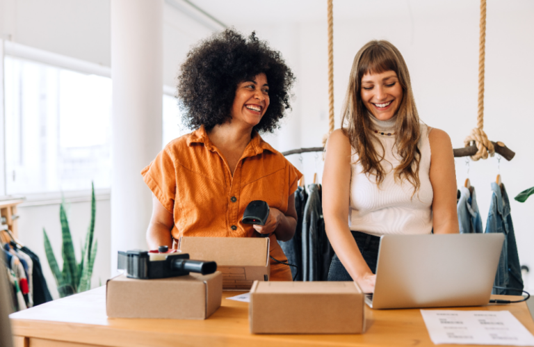 Photo of two women shipping packages to illustrate that it's all e-commerce