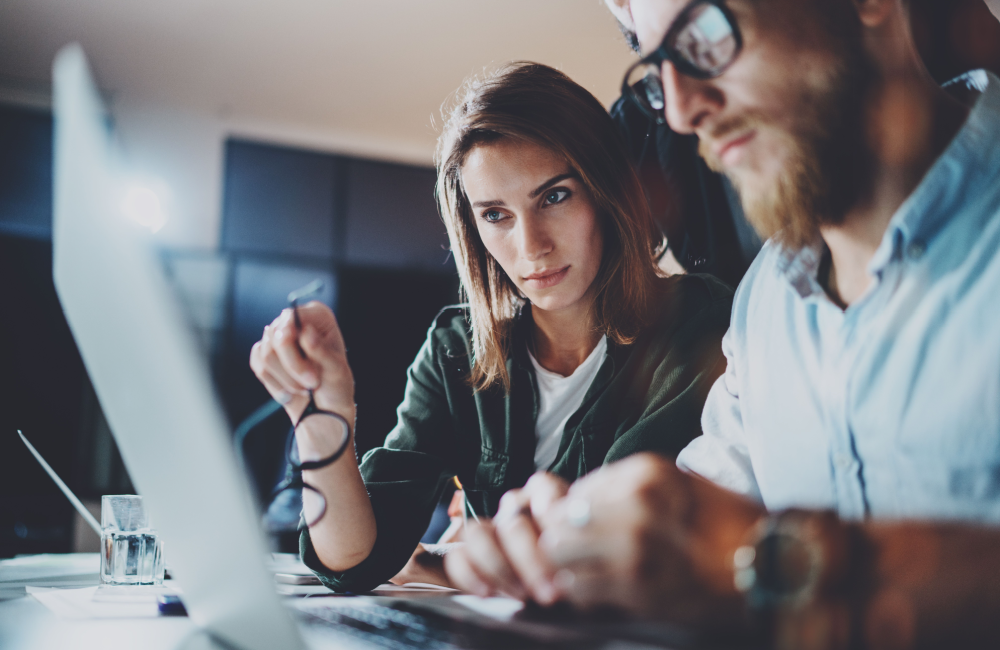 Man and woman working at computer to illustrate Big Tech earnings and Google's lack of vision